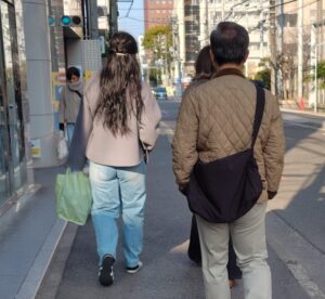 長崎堂の薄緑色の袋を持ち帰る客